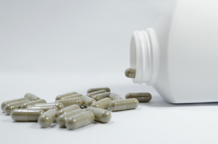 Pills spilling from a bottle